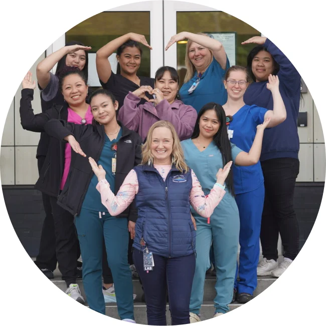 Woman employees forming a heart shape with their arms.