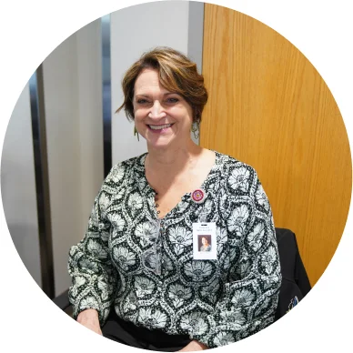 Woman employee smiling in an office.